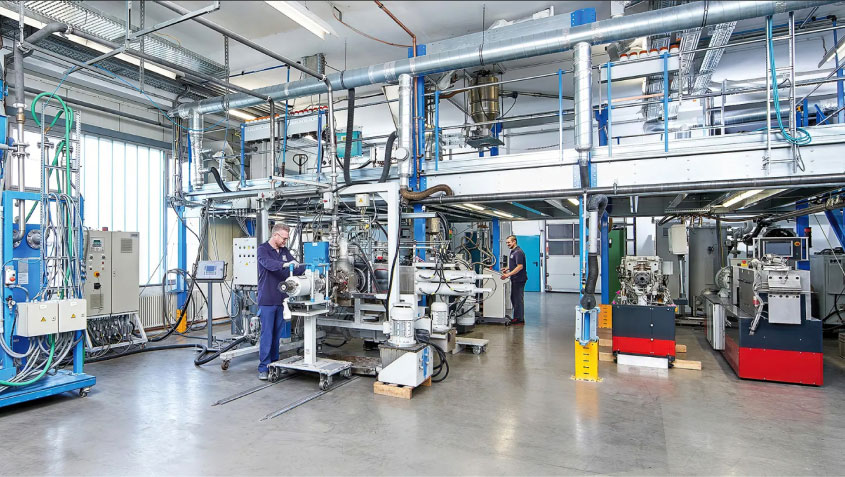 photo of lots of machinery and man working on machine