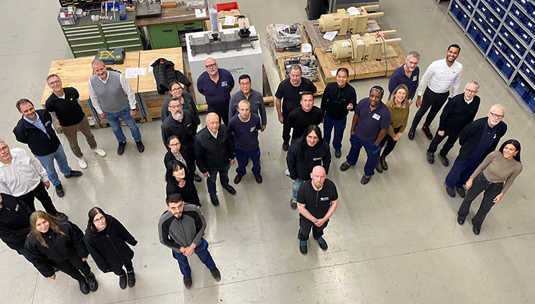 Looking down from high above to a group of employees in a warehouse looking up