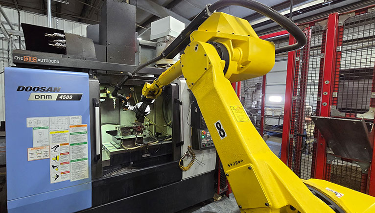 machinery with yellow robot arm